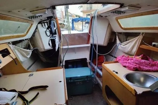 Slide: The Image of Interior of a 1983 Cape Bay Fast 40 sailboat, featuring compact living space and amenities. - 6