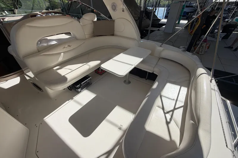 Slide: The Image of Luxurious seating area on a 2000 Sea Ray 410 Sundancer yacht, featuring elegant white upholstery. - 13