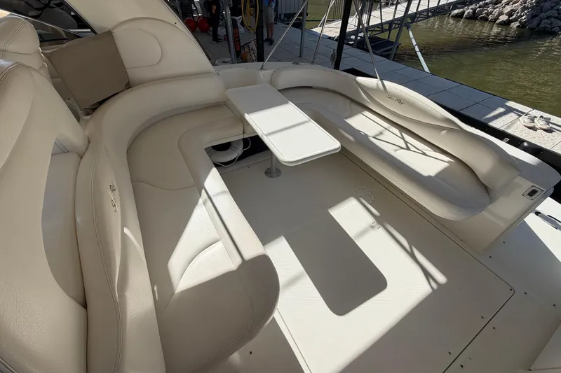 Slide: The Image of Luxurious seating area on a 2000 Sea Ray 410 Sundancer yacht, docked by the water. - 14