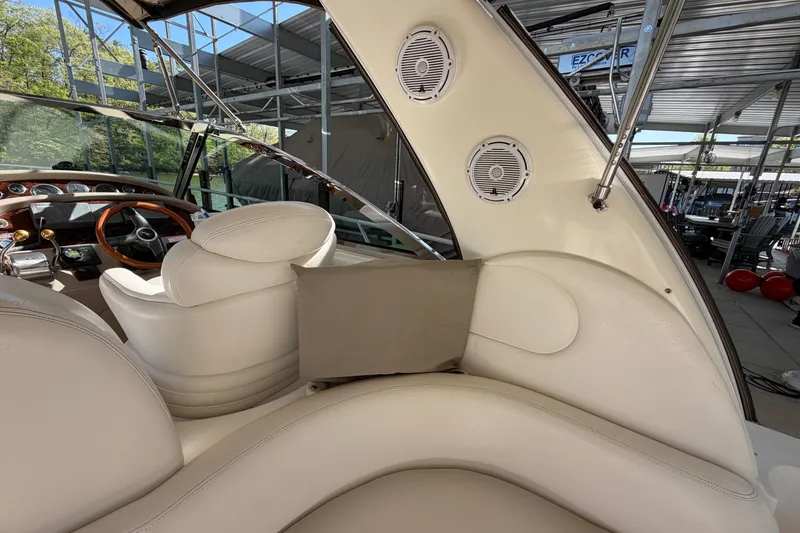 Slide: The Image of Interior of a 2000 Sea Ray 410 Sundancer yacht with white seating and dashboard. - 16