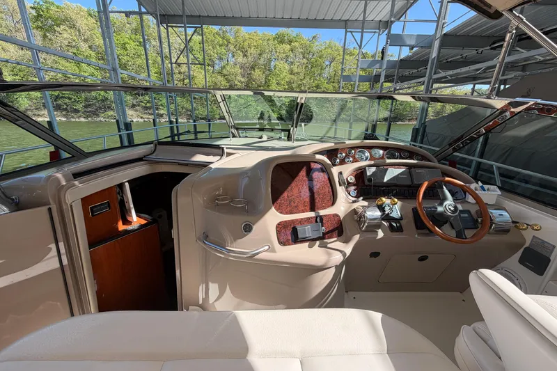 Slide: The Image of Interior view of 2000 Sea Ray 410 Sundancer yacht cockpit with steering wheel and controls. - 17