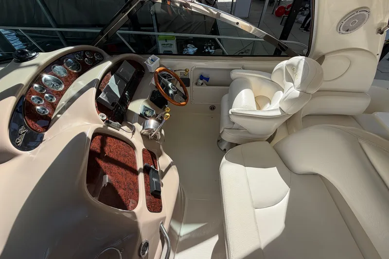 Slide: The Image of Luxurious helm of 2000 Sea Ray 410 Sundancer with leather seating and wood accents. - 19