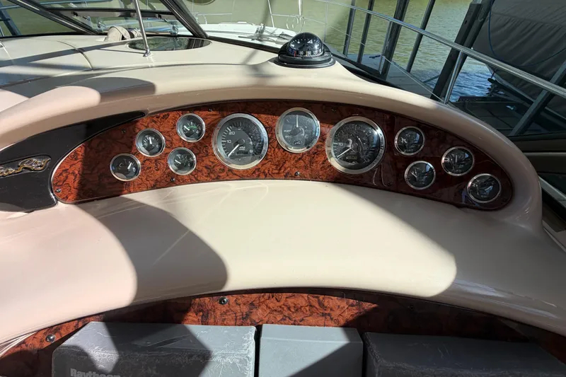 Slide: The Image of Dashboard of a 2000 Sea Ray 410 Sundancer with wood paneling and gauges. - 20