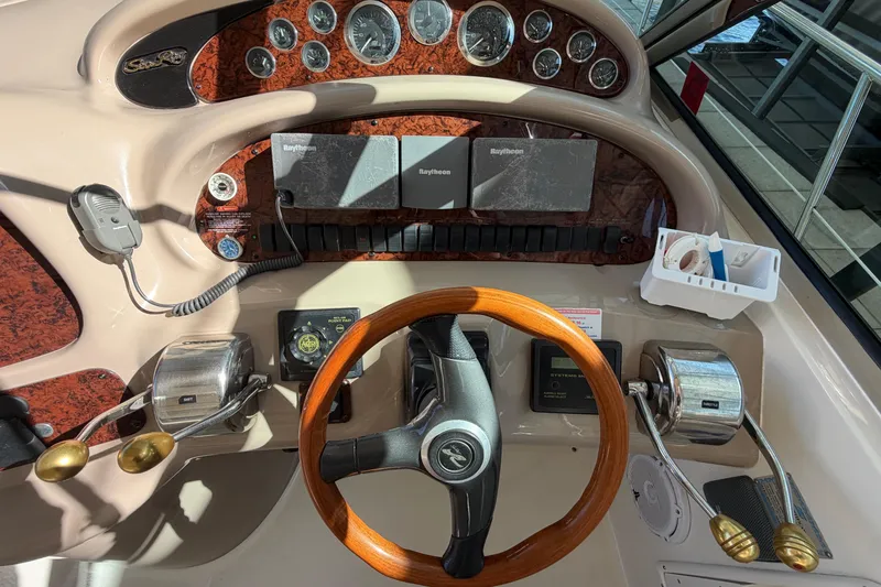 Slide: The Image of Cockpit of 2000 Sea Ray 410 Sundancer with wood steering wheel and control panel. - 21