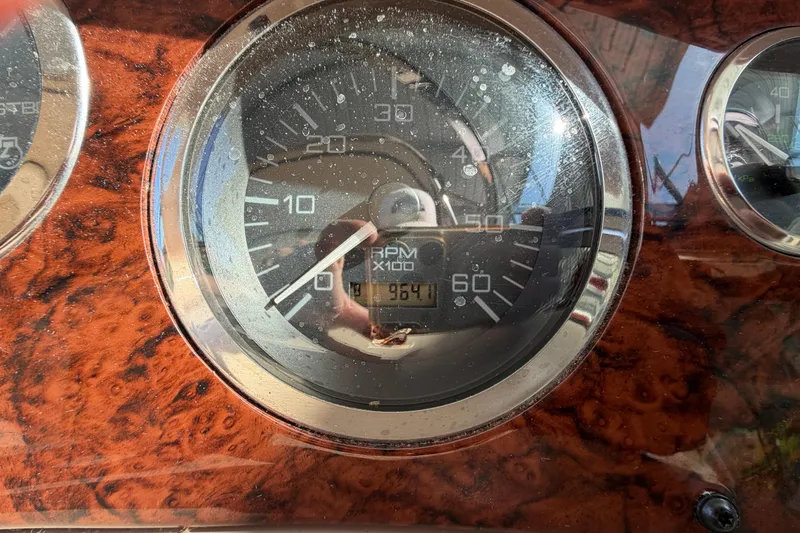 Slide: The Image of Close-up of a 2000 Sea Ray 410 Sundancer RPM gauge showing 964.1 hours. - 22