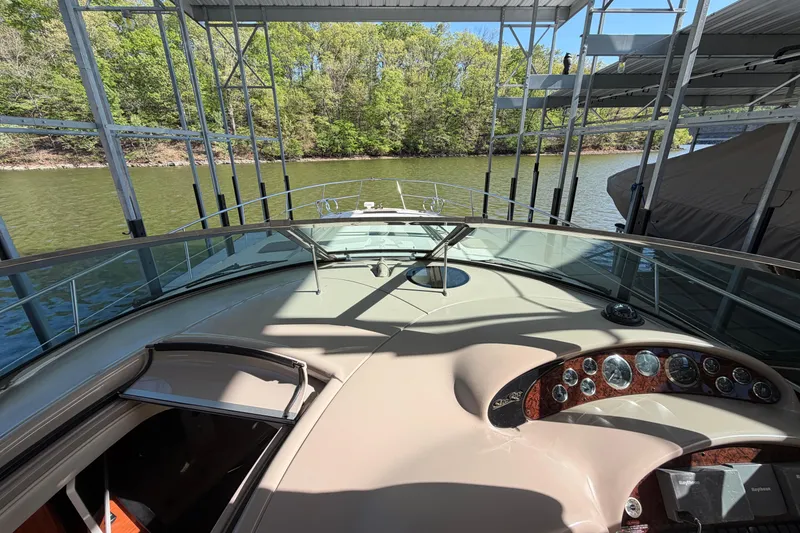 Slide: The Image of 2000 Sea Ray 410 Sundancer yacht cockpit view, docked on a serene lake. - 25