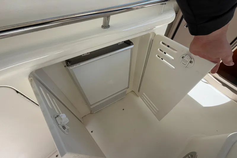 Slide: The Image of Storage compartment on a 2000 Sea Ray 410 Sundancer boat, with open door. - 27