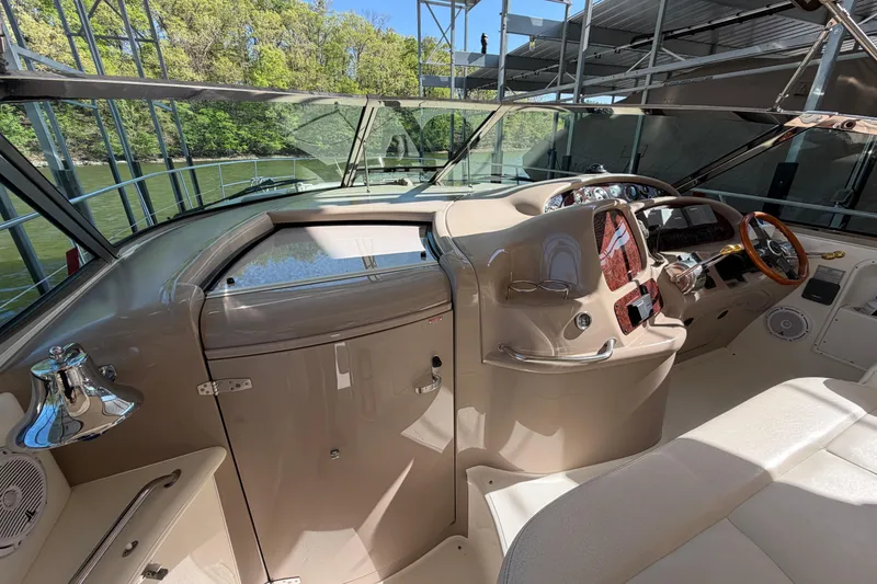 Slide: The Image of Cockpit of 2000 Sea Ray 410 Sundancer with steering wheel and control panel. - 28