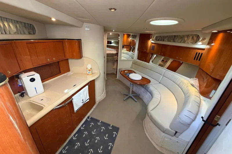 Slide: The Image of Luxurious interior of a 2000 Sea Ray 410 Sundancer yacht with elegant seating and kitchenette. - 30