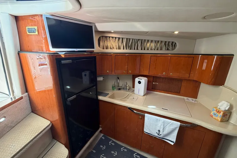 Slide: The Image of Luxurious 2000 Sea Ray 410 Sundancer yacht interior with modern kitchen amenities. - 32