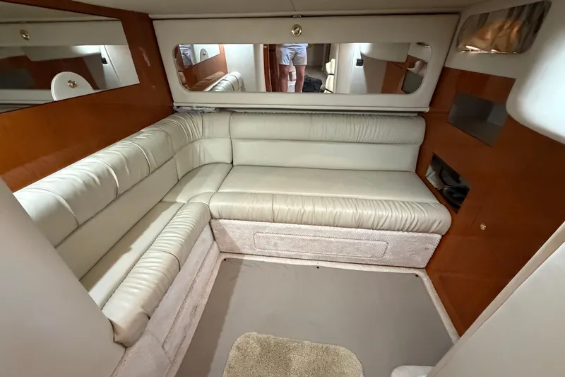 Slide: The Image of Interior of 2000 Sea Ray 410 Sundancer yacht with cream leather seating and wood accents. - 38