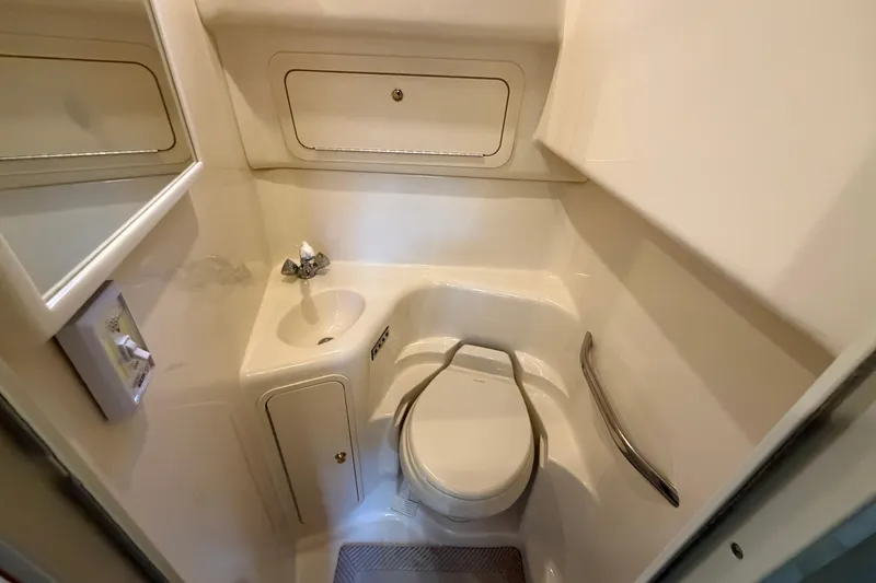Slide: The Image of Compact bathroom in 2000 Sea Ray 410 Sundancer yacht, featuring toilet and sink. - 39