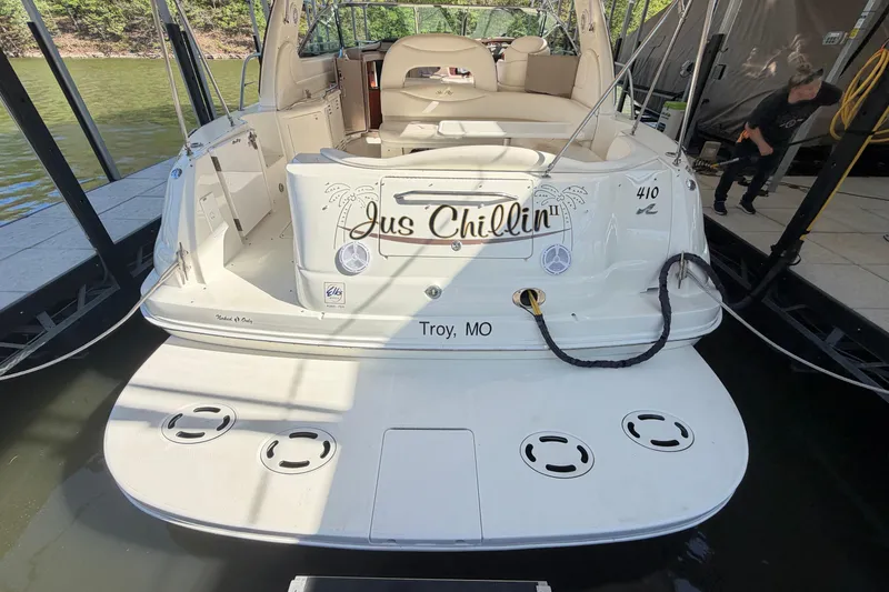 Slide: The Image of 2000 Sea Ray 410 Sundancer boat docked, named "Jus Chillin," with spacious swim platform. - 4