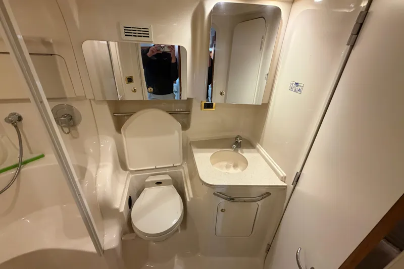 Slide: The Image of Bathroom interior of 2000 Sea Ray 410 Sundancer yacht, featuring toilet, sink, and shower. - 40