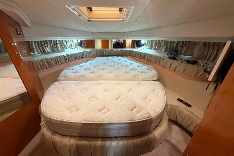 Slide: The Image of Luxurious cabin interior of 2000 Sea Ray 410 Sundancer yacht with plush bedding. - 42