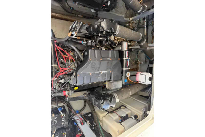 Slide: The Image of Engine compartment of a 2000 Sea Ray 410 Sundancer with visible wiring and components. - 47