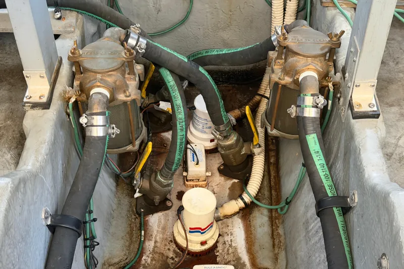 Slide: The Image of Engine compartment of a 2000 Sea Ray 410 Sundancer with hoses and filters visible. - 51
