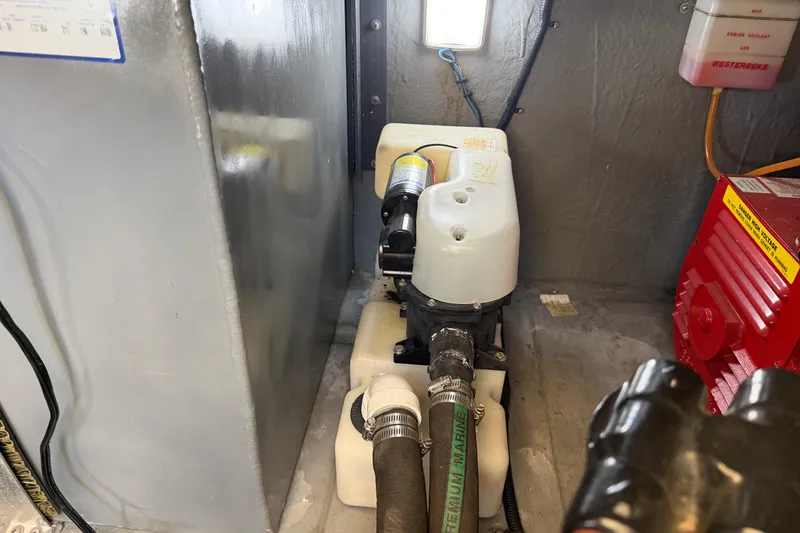 Slide: The Image of Engine compartment of a 2000 Sea Ray 410 Sundancer with visible machinery and components. - 52