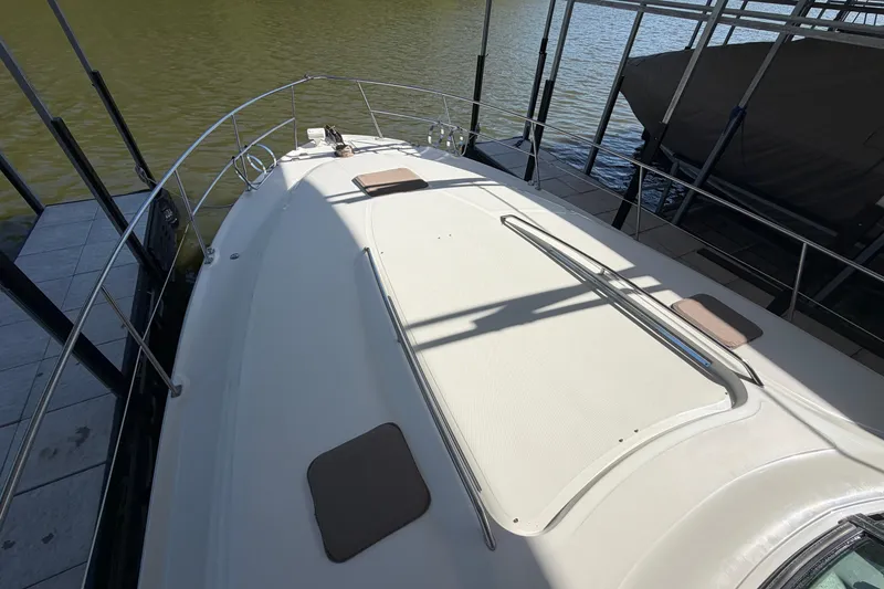 Slide: The Image of Deck view of a 2000 Sea Ray 410 Sundancer yacht docked by the water. - 7