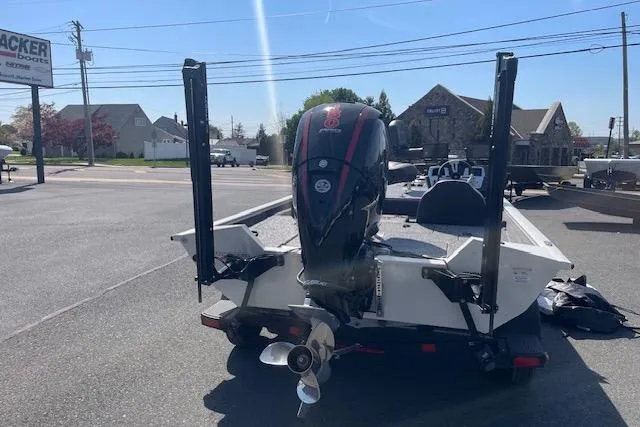 Slide: The Image of 2025 Tracker Pro Team 195 Tournament Edition boat with powerful outboard motor, parked outdoors. - 9