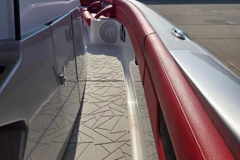 Slide: The Image of 2019 Mystic Powerboats M4200 interior with red leather accents and geometric flooring design. - 19