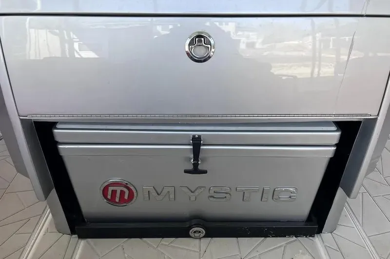 Slide: The Image of 2019 Mystic Powerboats M4200 storage compartment with branded cooler. - 22