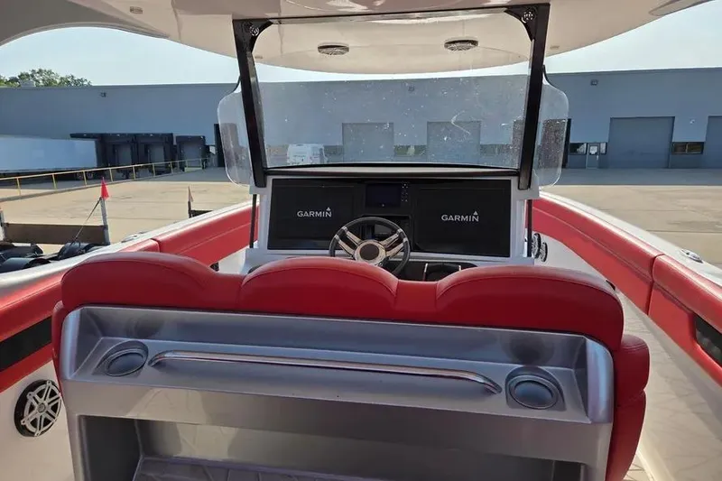 Slide: The Image of 2019 Mystic Powerboats M4200 cockpit with Garmin navigation, red seating, and modern controls. - 9