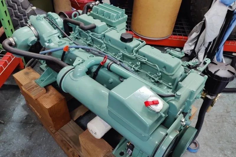 Slide: The Image of Green Mako 286 engine from 1991 on wooden blocks in a workshop. - 10