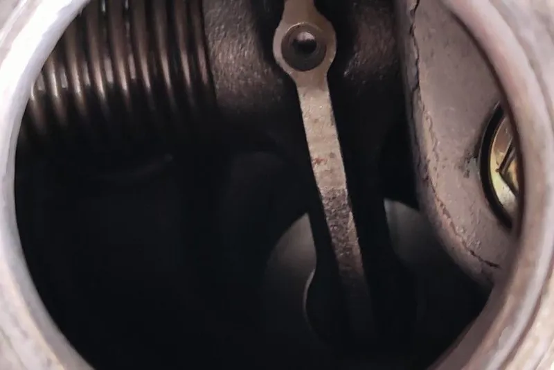 Slide: The Image of Close-up of a 1991 Mako 286 engine component, showing intricate metal parts. - 15