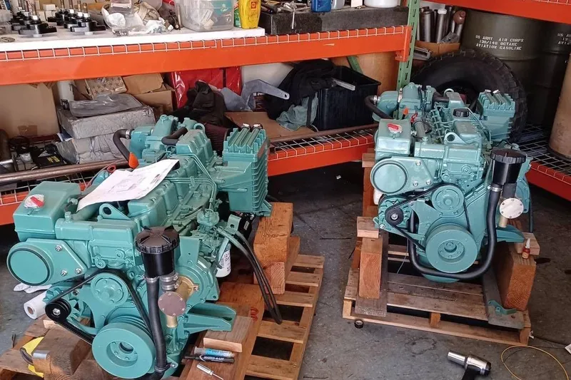 Slide: The Image of Two teal Mako 286 engines from 1991 on wooden pallets in a workshop. - 19