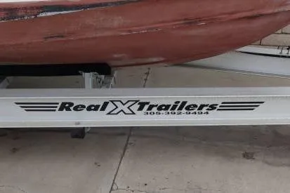 Slide: The Image of Trailer with "Real X Trailers" branding, supporting a 1991 Mako 286 boat. - 20