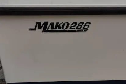 Slide: The Image of 1991 Mako 286 boat model logo on white surface. - 21