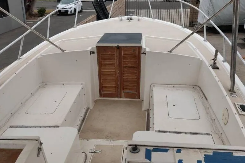 Slide: The Image of 1991 Mako 286 boat interior with storage compartments and wooden doors. - 6
