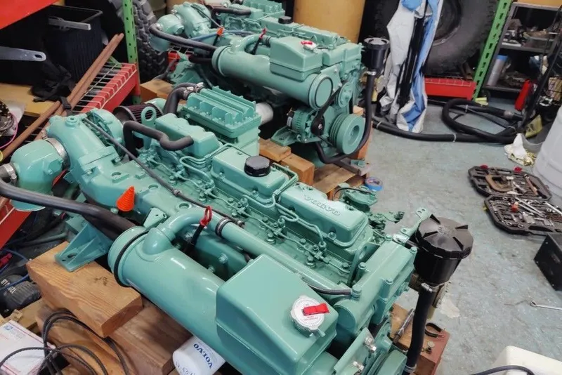 Slide: The Image of Green Mako 286 engines from 1991 on wooden pallets in a workshop setting. - 9