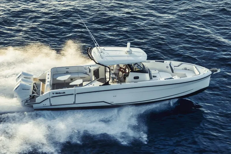 Slide: The Image of Manufacturer Provided Image: 2026 Wellcraft 38 T-Top boat cruising on open water, showcasing sleek design and powerful engines. - 5