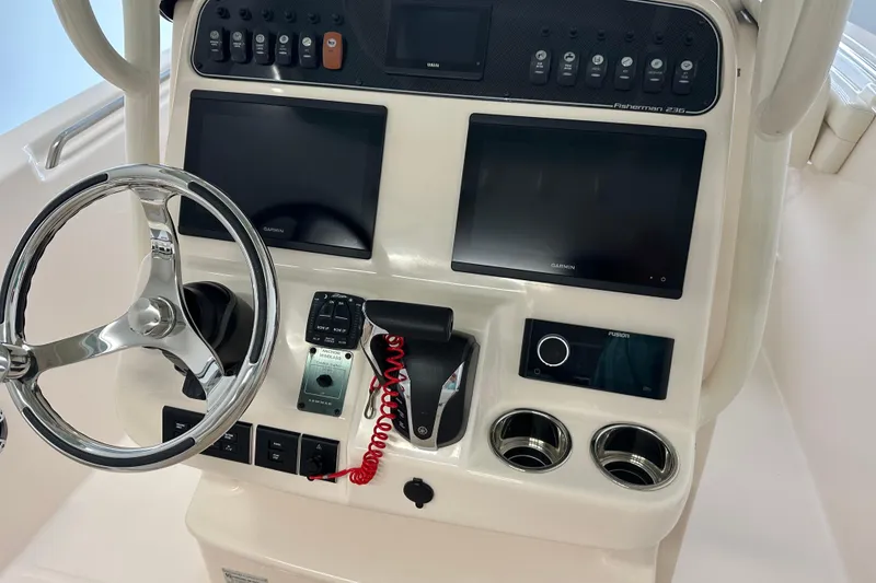 Slide: The Image of 2023 Grady-White Fisherman 236 boat dashboard with steering wheel and electronic displays. - 11