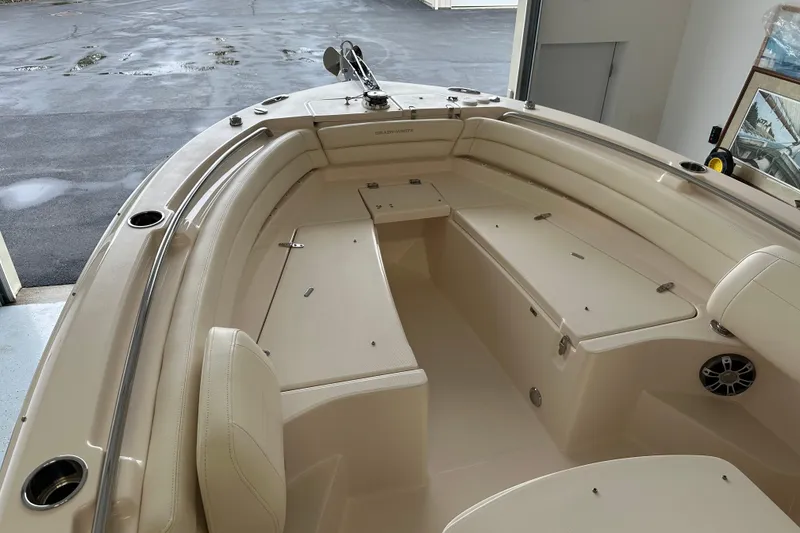 Slide: The Image of 2023 Grady-White Fisherman 236 boat interior with beige seating and storage compartments. - 15