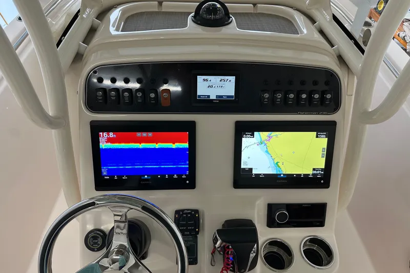 Slide: The Image of 2023 Grady-White Fisherman 236 dashboard with navigation and sonar displays. - 21