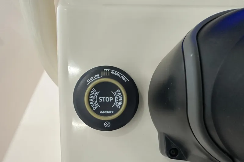Slide: The Image of Control panel on 2023 Grady-White Fisherman 236 boat, featuring a stop button. - 22