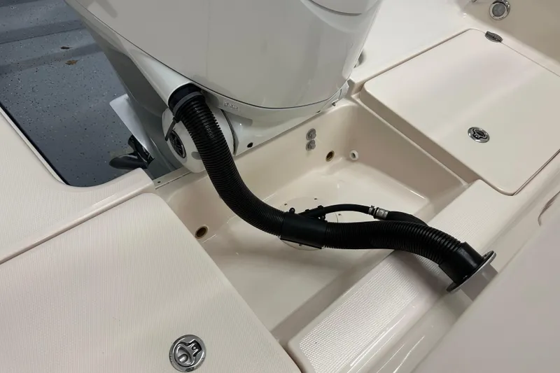 Slide: The Image of 2023 Grady-White Fisherman 236 boat engine compartment with hose connections. - 25