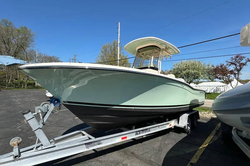 Slide: The Image of 2023 Grady-White Fisherman 236 boat on trailer, parked outdoors under clear blue sky. - 3