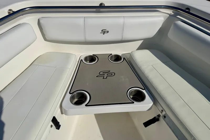 Slide: The Image of 2018 Sea Pro 219 Center Console boat interior with cushioned seating and cup holders. - 10