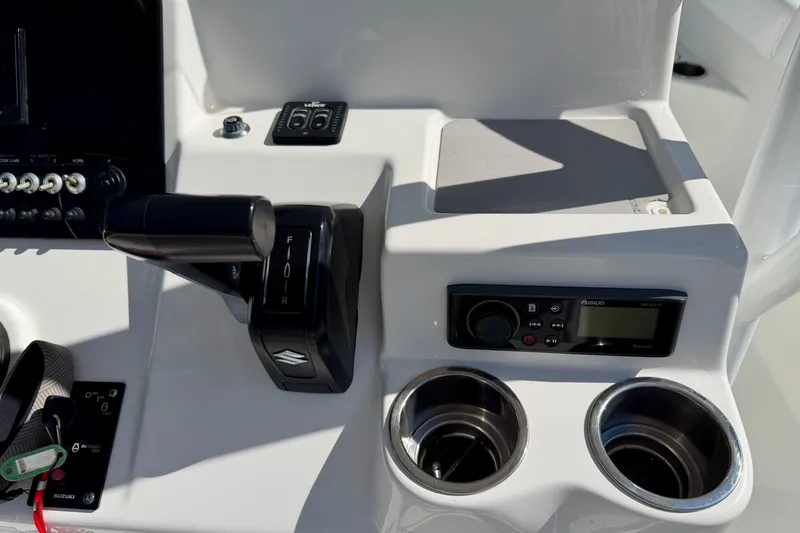 Slide: The Image of 2018 Sea Pro 219 Center Console dashboard with controls and cup holders. - 18
