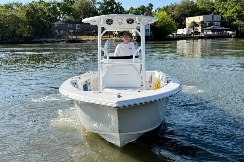 Slide: The Image of 2018 Sea Pro 219 Center Console boat cruising on a calm river. - 2