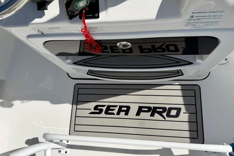 Slide: The Image of 2018 Sea Pro 219 Center Console boat interior with logo and safety instructions. - 23