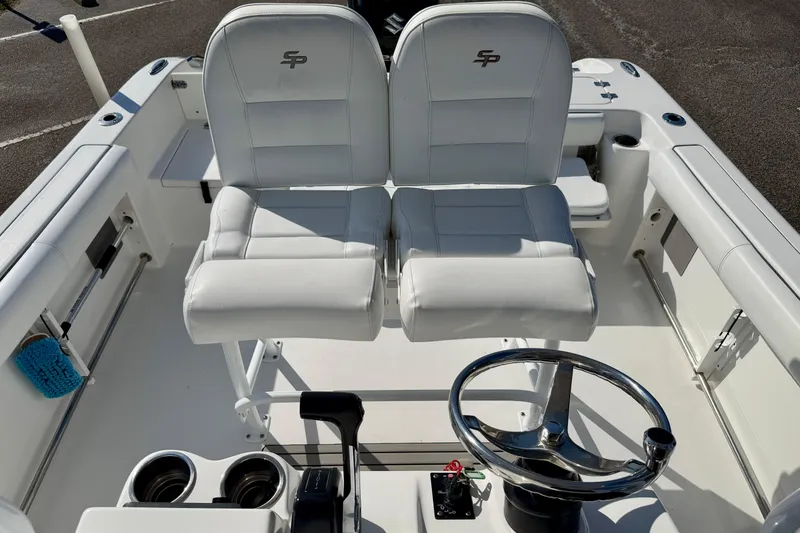 Slide: The Image of 2018 Sea Pro 219 Center Console boat interior with dual seats and steering wheel. - 24