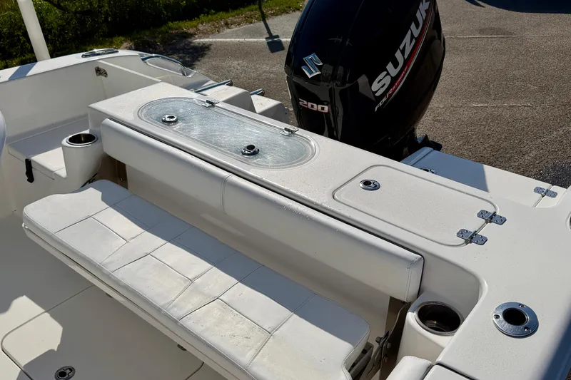 Slide: The Image of 2018 Sea Pro 219 Center Console boat with Suzuki 200 engine, featuring seating and storage. - 27