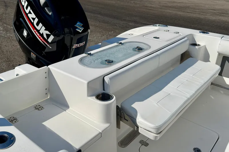 Slide: The Image of 2018 Sea Pro 219 Center Console boat with Suzuki 200 engine, featuring white seating and livewell. - 28