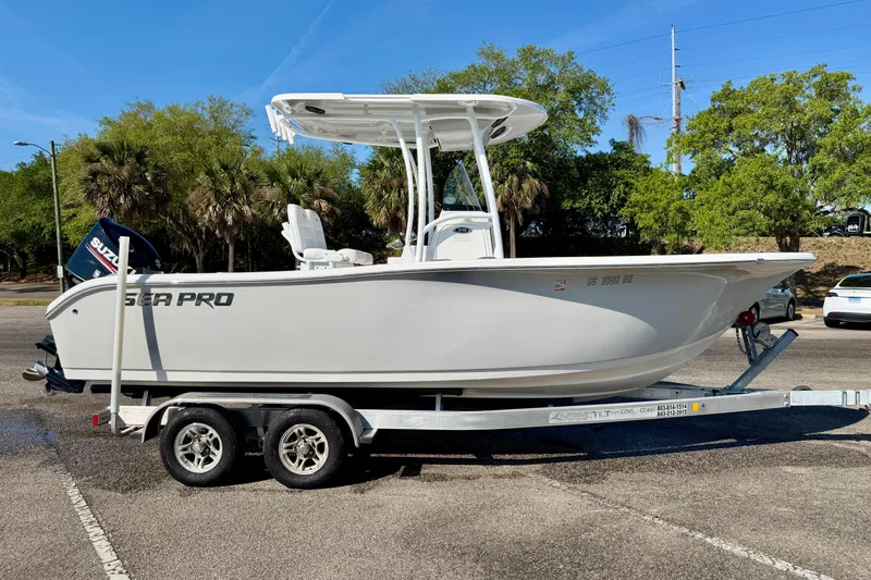 Slide: The Image of 2018 Sea Pro 219 Center Console boat on trailer in sunny parking lot. - 38