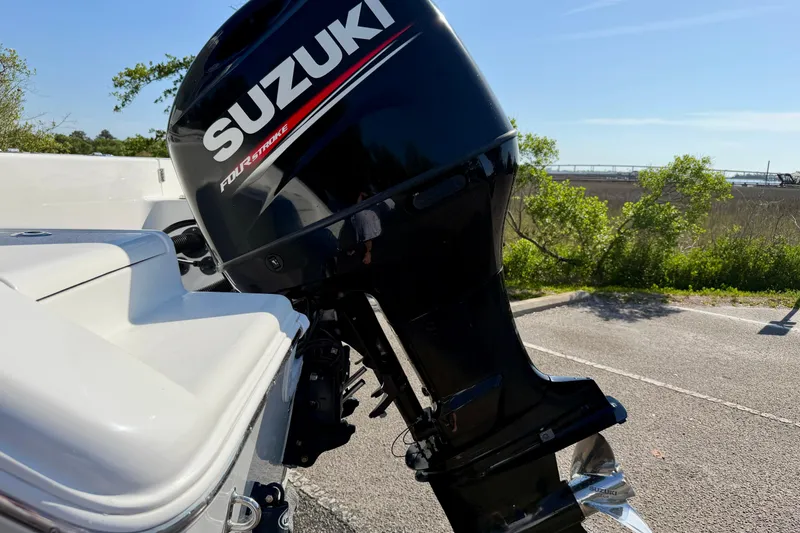 Slide: The Image of 2018 Sea Pro 219 Center Console with Suzuki four-stroke outboard motor in a sunny setting. - 39